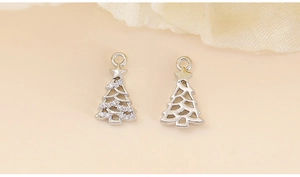 Macro detail of silver Christmas tree pendants with zircon inlay and silk decor