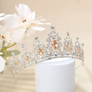 Detail of luxury silver tiara with champagne water-drop gems and rhinestones on pedestal