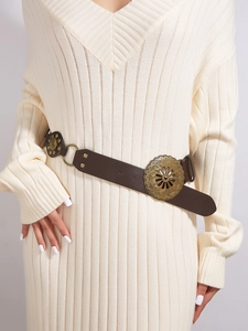 Macro detail of dark brown leather belt with vintage floral buckles and metal rivets