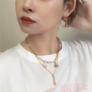Layered gold necklace and earrings set with rainbow, pearl, and LOVE pendants