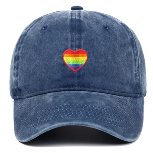 Detailed view of rainbow heart embroidery on dark blue washed cotton baseball cap