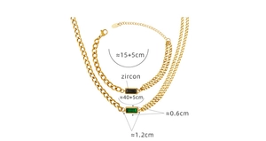 Detail of gold chain jewelry set with green and black rectangular zircon stones