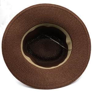 Detailed view of the dark brown straw hat interior with adjustable sweatband drawstring