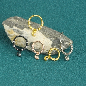Detailed view of 316L stainless steel moon and star nose rings with zircon and pearls