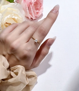 Close-up of a 14K gold plated sterling silver ring with a square Asscher cut moissanite
