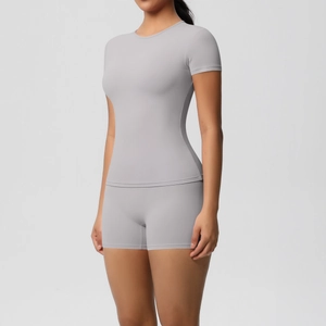 Detail of high-elasticity grey yoga set showing premium brushed fabric and tight fit