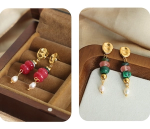 Detail of bohemian drop earrings with natural stone beads and pearls on a gold-plated base