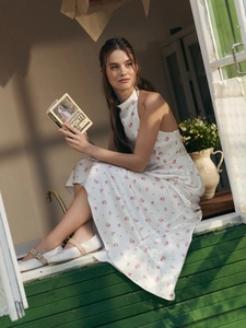 Detail of white floral satin maxi dress with bubble hem and mock neck design