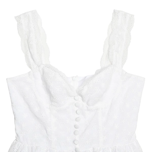Close-up of white lace dress featuring floral embroidery, heart neckline and buttons