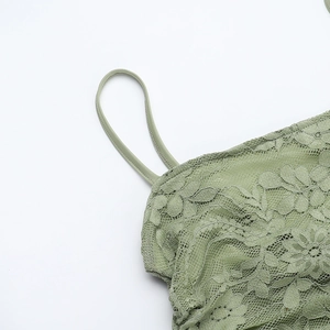 Close-up of avocado green lace fabric detail and stitching on a slim fit dress