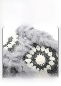 Detail of hand-crocheted floral pattern and plush grey faux fur lining on winter hat