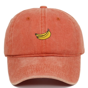 Detailed close-up of coral orange washed cotton baseball cap with banana embroidery