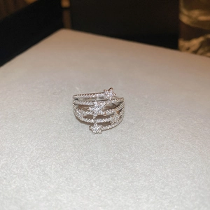 Macro detail of layered silver star ring with micro-pave cubic zirconia settings