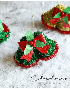 Close-up of red and green Christmas bell pendant with a bow and glitter texture