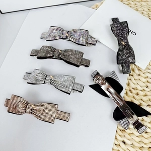 Detail shot of elegant bow hair clips with shimmering crystals in five various colors