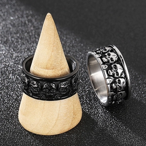Close-up of punk style skull embossed rings in black and silver stainless steel