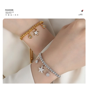 Detail of beaded star charm bracelets in gold and silver finish with pavé crystals