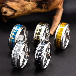 Men's stainless steel cross rings in five assorted finishes on rustic wood stand