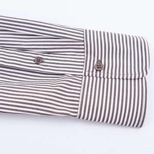 Detail view of the striped shirt cuff with high-quality stitching and single button closure