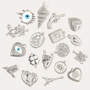 Collection of silver stainless steel charms featuring heart, snake, and clover designs
