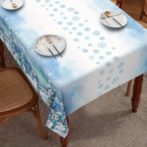 Detail of Christmas tablecloth featuring snowman and snowflake patterns on a dining table