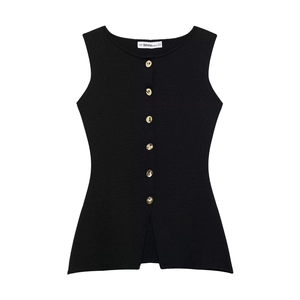 Detail of black knit vest with golden buttons and a subtle split hem design