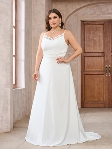 Close-up of delicate lace embroidery on the neckline of a white plus size gown