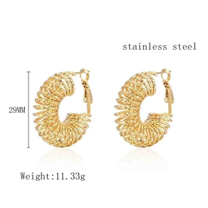 Detail view of 29mm gold stainless steel spring hoop earrings with spiral texture