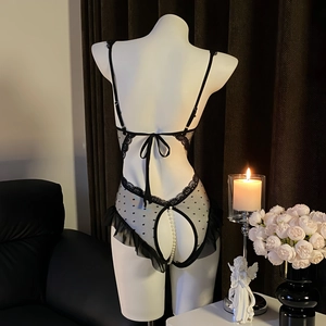 Sexy black lace teddy with polka dot mesh, pearl crotch chain and ruffled hem on a mannequin