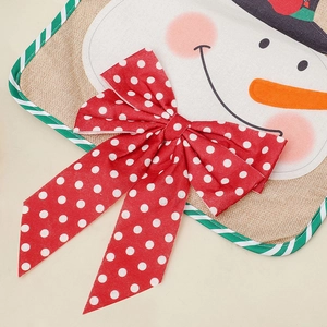 Detail of Christmas burlap table runner featuring snowman face and red polka dot bow