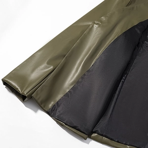 Detailed view of olive green faux leather jacket hem with black lining and stitching