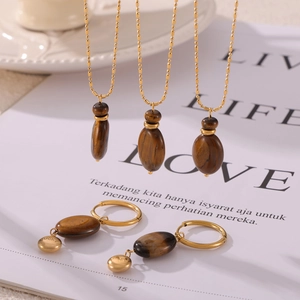 Elegant gold titanium steel jewelry set featuring brown tiger eye necklaces and earrings