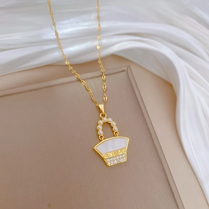 Luxury gold bag necklace with pearl shell inlay and GENIUS lettering on silk background