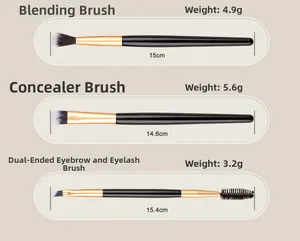 Detail view of double-ended eyebrow and eyeshadow brushes with black and gold handles