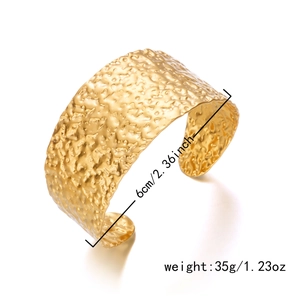 Detail of 6cm diameter hammered gold cuff bracelet with 35g weight specifications