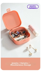 Macro view of portable orange organizer box storing rings and fashion accessories