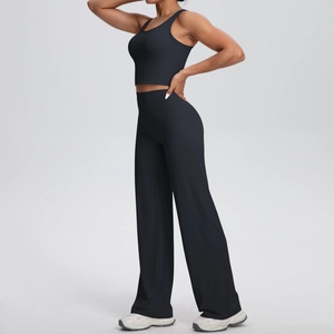 Dettaglio del set fitness nero con crop top e pantaloni a gamba larga a vita alta