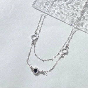 Double-layer silver necklace with black roman numeral pendant and openwork circles