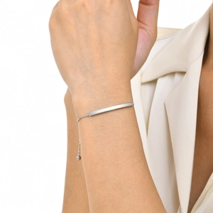Close-up of minimalist silver curved bar bracelet with adjustable chain on wrist