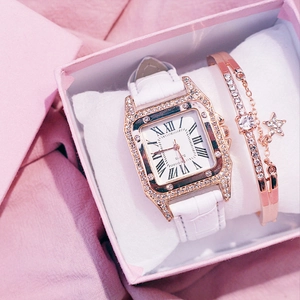 Close-up of rose gold square watch with crystal bezel and matching star bracelet in gift box