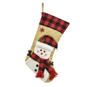 Detail of 3D plush snowman on burlap Christmas stocking with red black plaid cuff and hanger