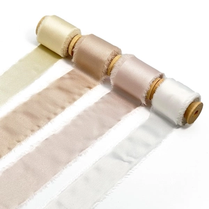 Frayed edge silk ribbons in cream, champagne and pink on wooden spools for DIY decor