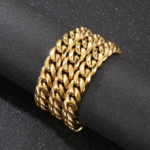 Macro shot of multi-layered golden Cuban link chain with glossy polished metal texture