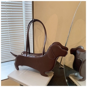 Detail of dachshund-shaped tote bag in dark brown faux leather with sleek carry handles