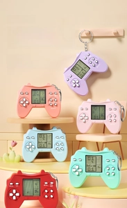 Close-up of mini retro game consoles in pastel colors with metal keychains and LCD screens