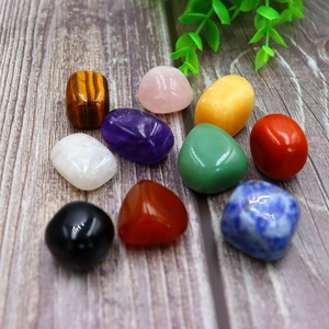 Macro view of 9 polished natural healing crystal stones on wood background