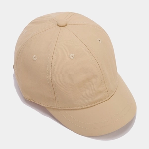 Detailed 45-degree angle view of breathable short brim baseball cap in beige fabric