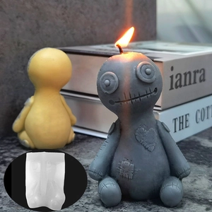 Detailed view of Voodoo doll candle mold with textured doll and lit wick detail