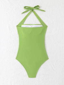 Flat lay of bright green halter neck one piece swimsuit with open back and soft inner lining