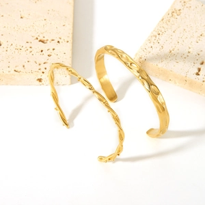 Set of two 18K gold plated stainless steel open bangles with hammered and vine textures